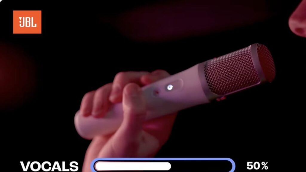 Close-up of the JBL EasySing wireless microphone with the vocal level graphic at 1:47