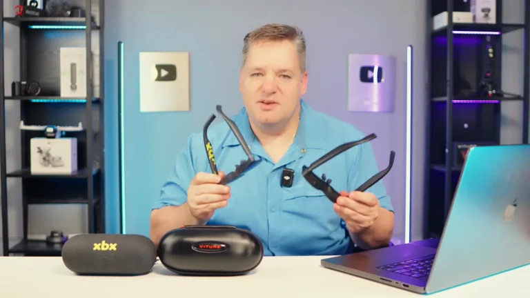 Curtis holding the VITURE Pro 2 and XREAL xbx a01+ XR glasses side by side