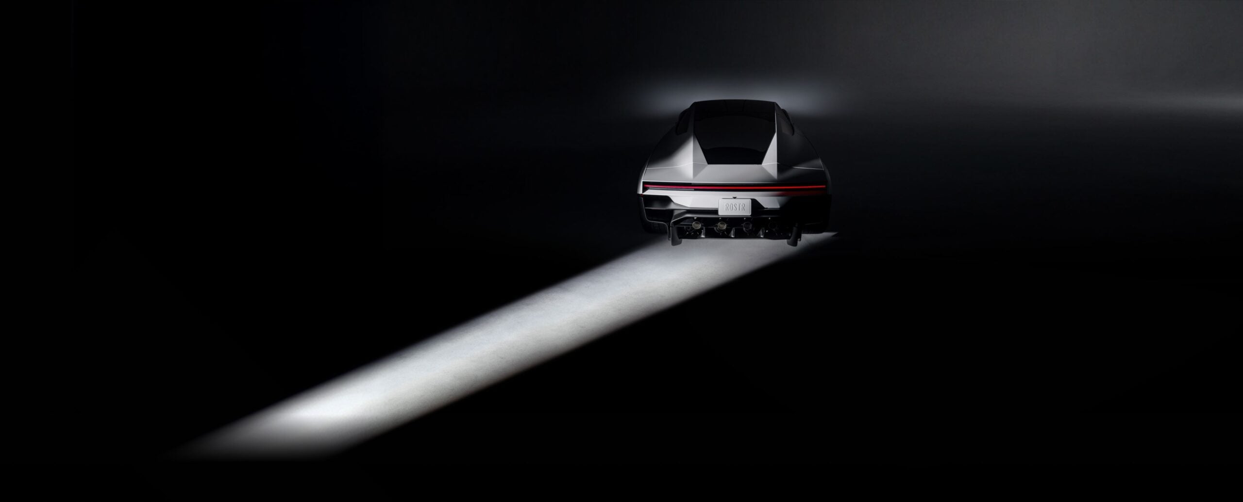 Tesla promotional rear view of the newly revealed angular Roadster, showing its red light bar and rear hardware